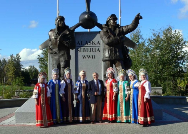 Sculptor R.T. Wallen with Russian folk dancers at the dedication of the Alaska-Siberia WWII monument, Fairbanks, Alaska